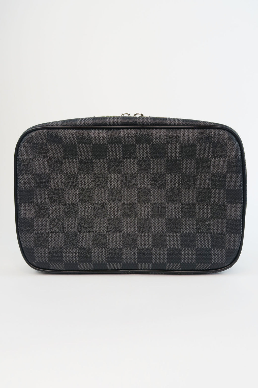 This Louis Vuitton Toletry Pouch in Damier Graphite canvas will protect  your shaving tools and treatments.